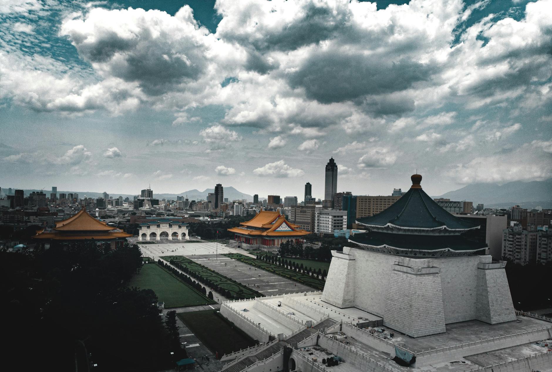 old masonry church near modern buildings under cloudy sky