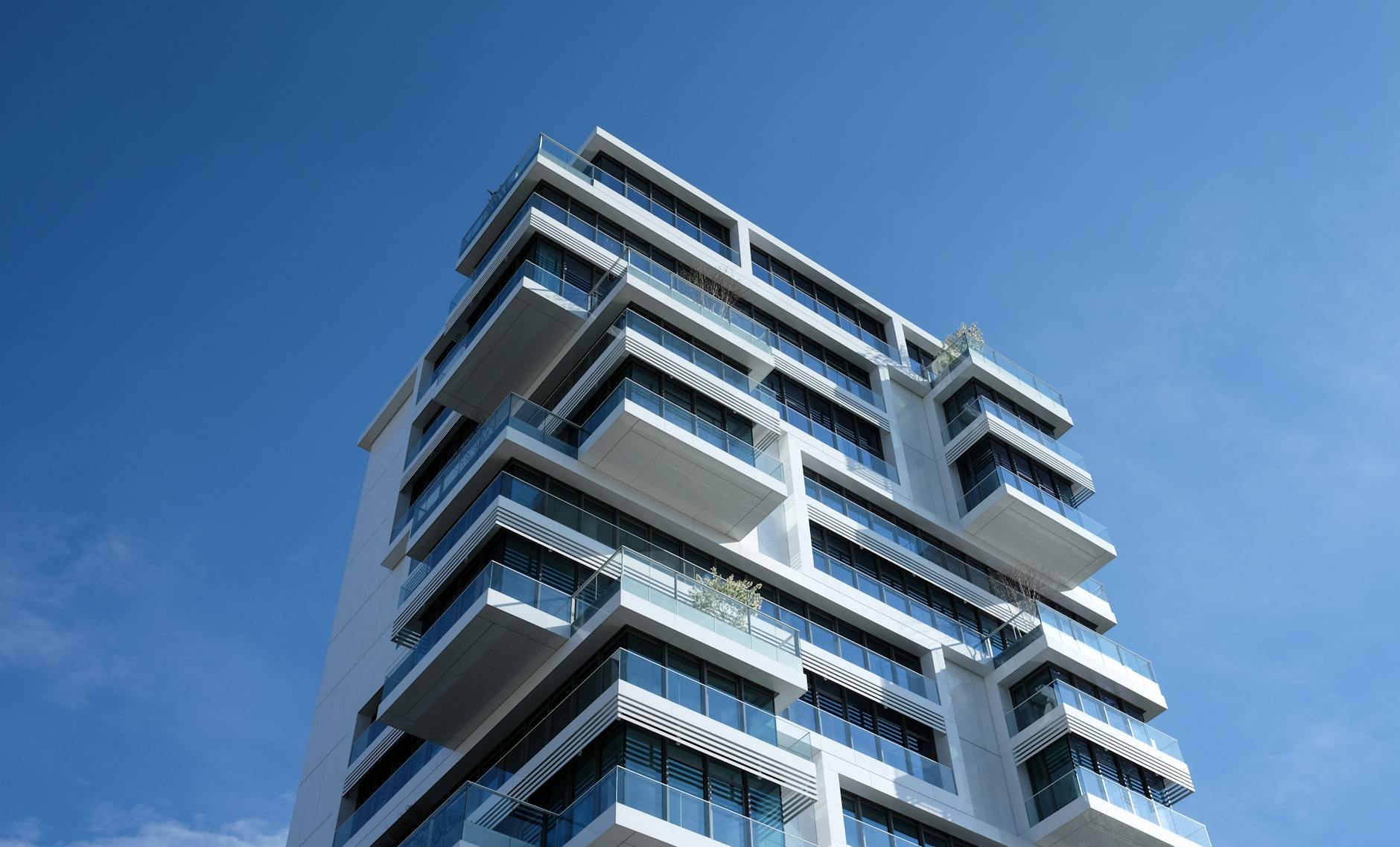 高雄市左營區房市現況 white concrete building under sunny blue sky