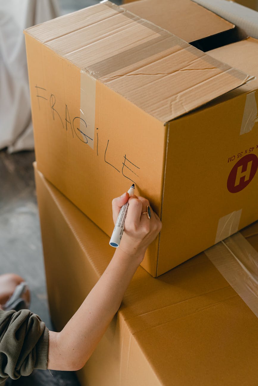 crop faceless woman sorting fragile carrying packages