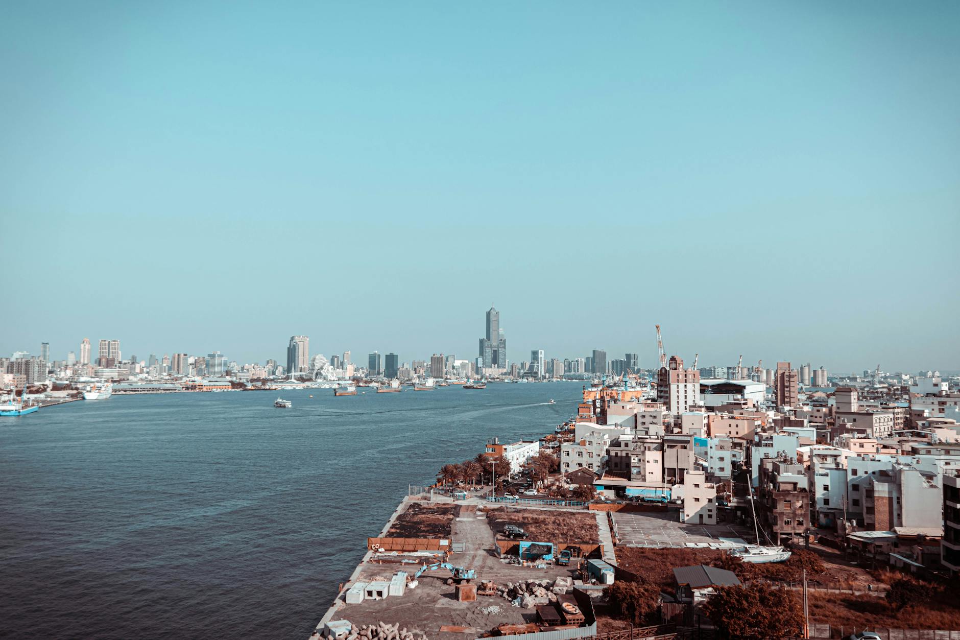 aerial photography of city buildings near ocean under the sky