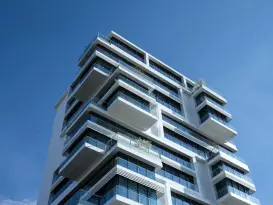 white concrete building under sunny blue sky