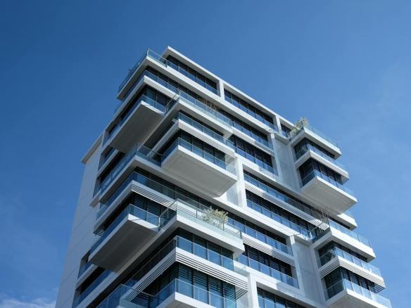 white concrete building under sunny blue sky