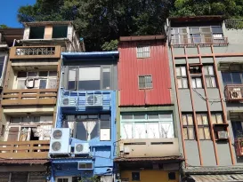 colorful urban buildings with lush backdrop