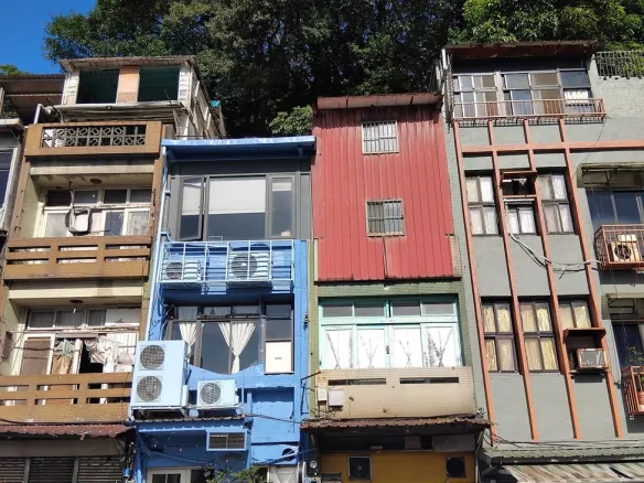colorful urban buildings with lush backdrop